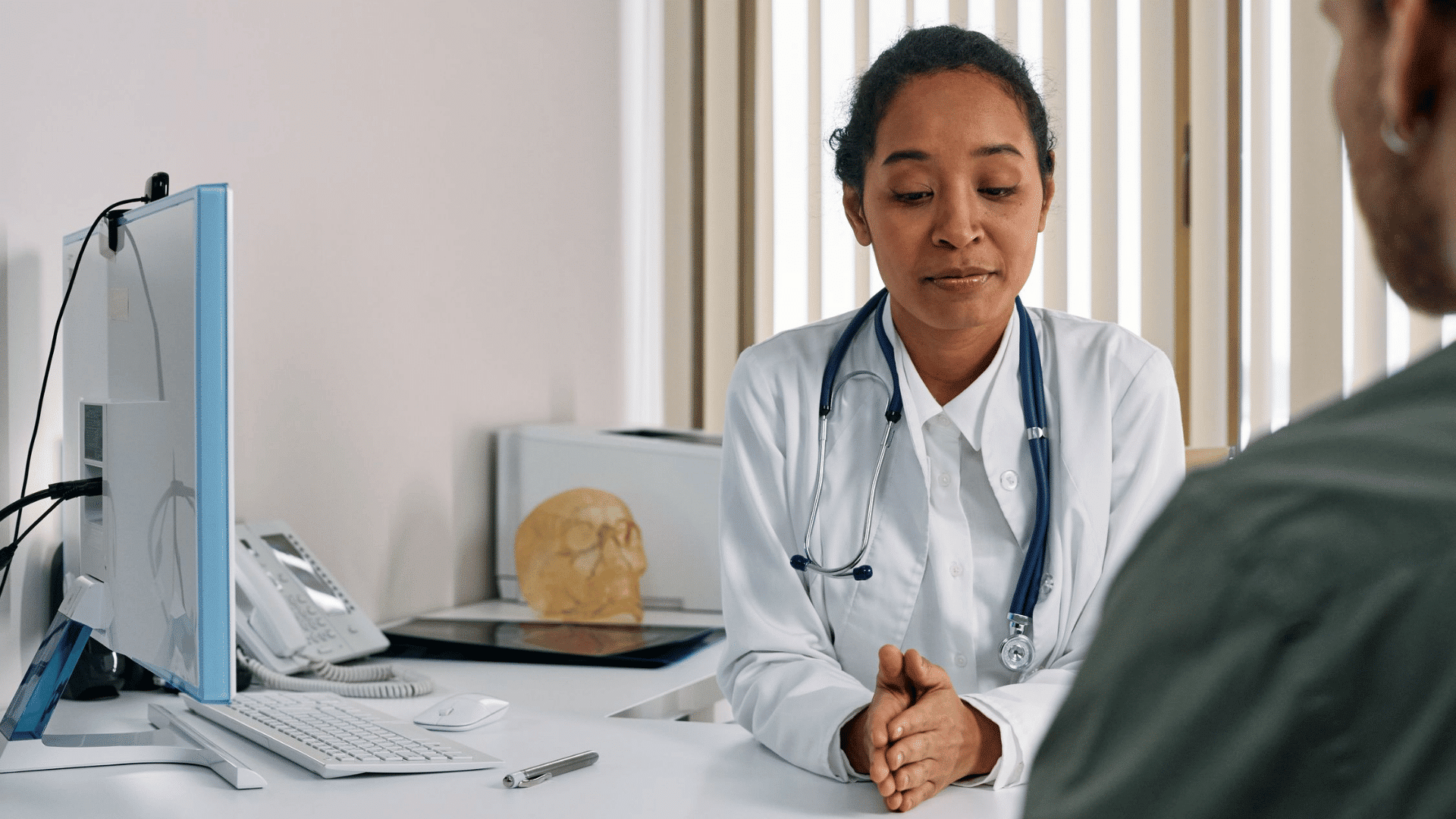a doctor listens attentively while speaking with a patient during a medical consultation