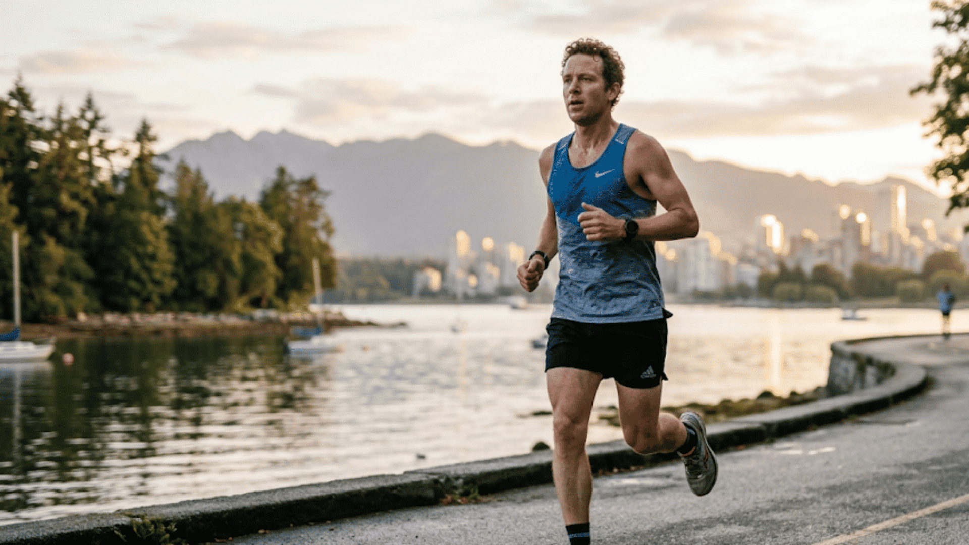 a man runs along a coastal path at sunset with cliffs ocean waves and trees in the background (1)