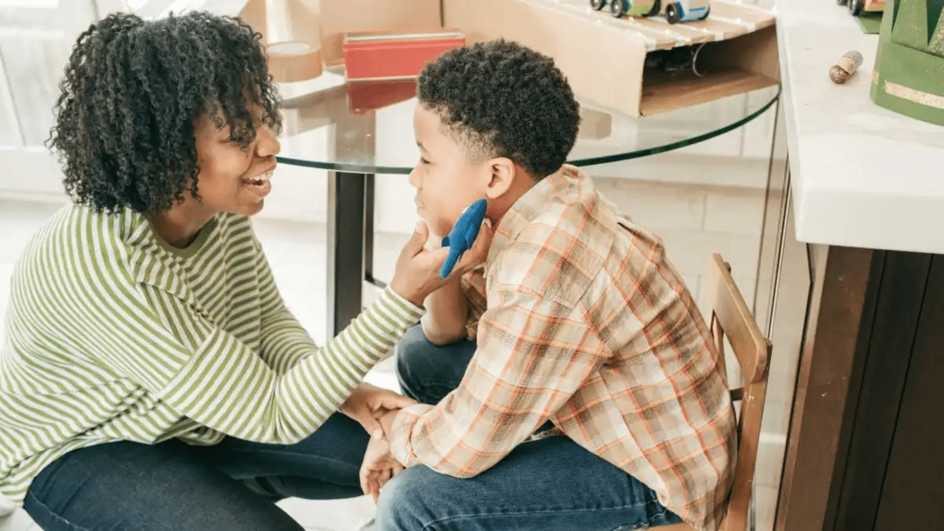 caregiver engaging with child through supportive interaction to encourage communication learning and emotional development skills