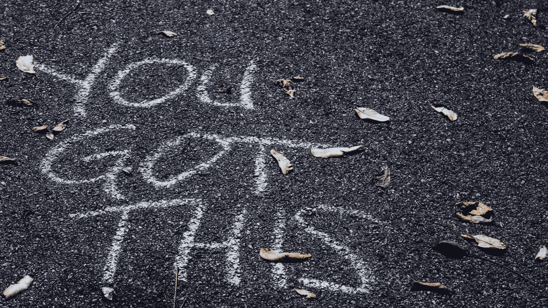 chalk message reading you got this on pavement surrounded by fallen leaves offering encouragement and support