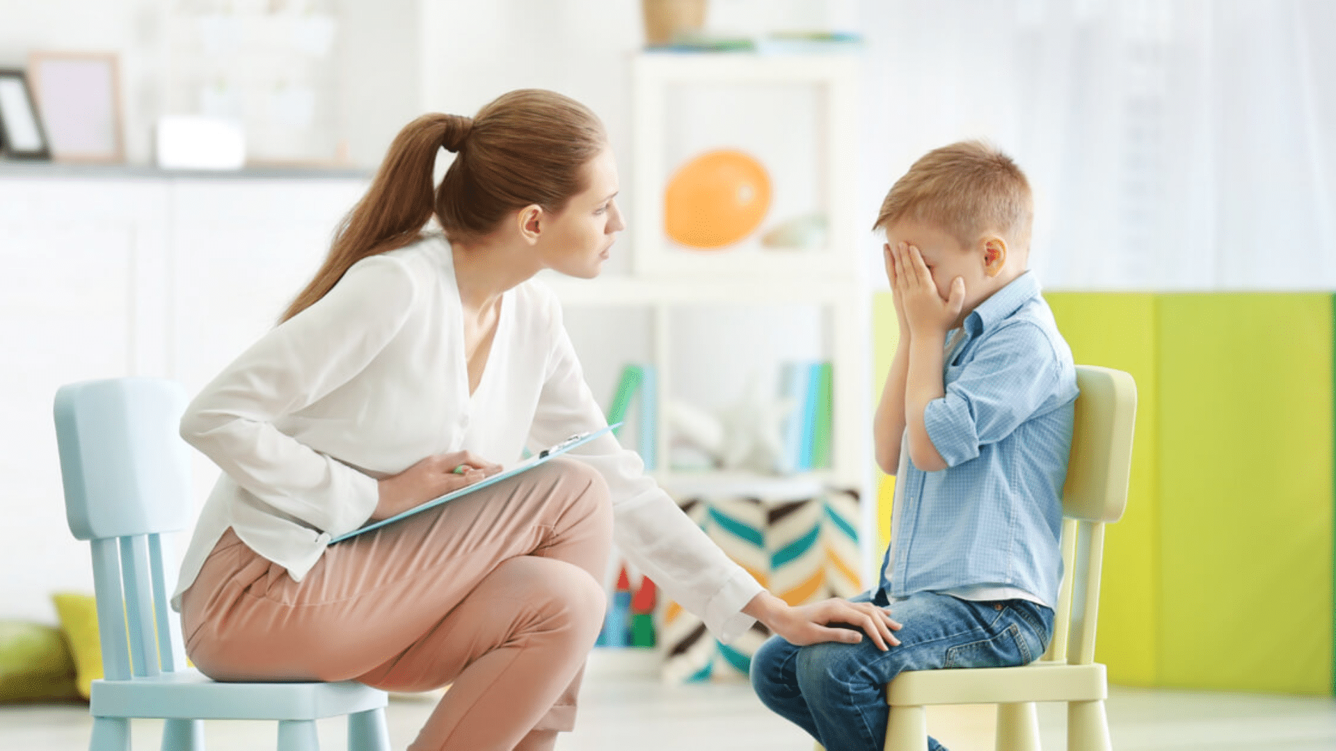 child receiving support from therapist during session focused on emotional regulation communication and developmental needs