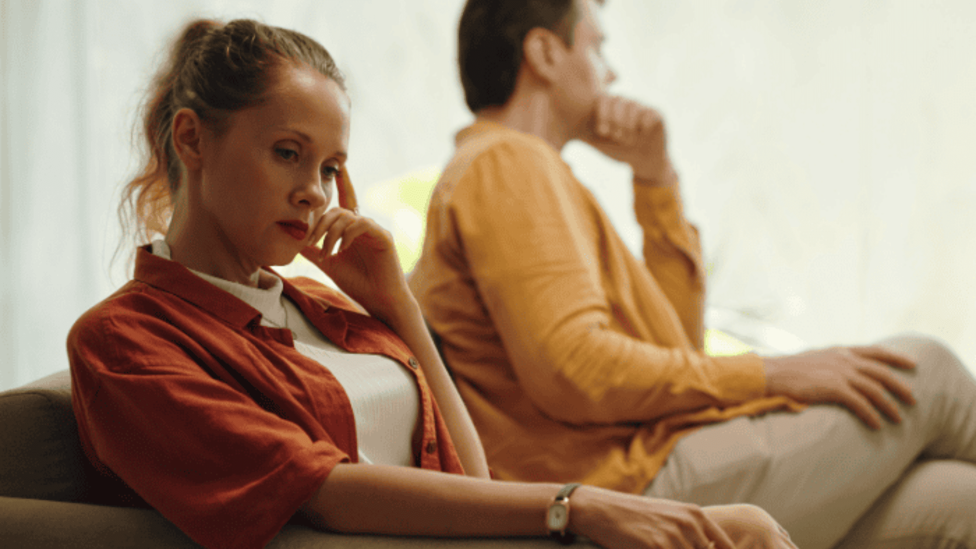 couple sitting apart showing emotional distance communication struggles and relationship challenges linked to attachment issues and trust