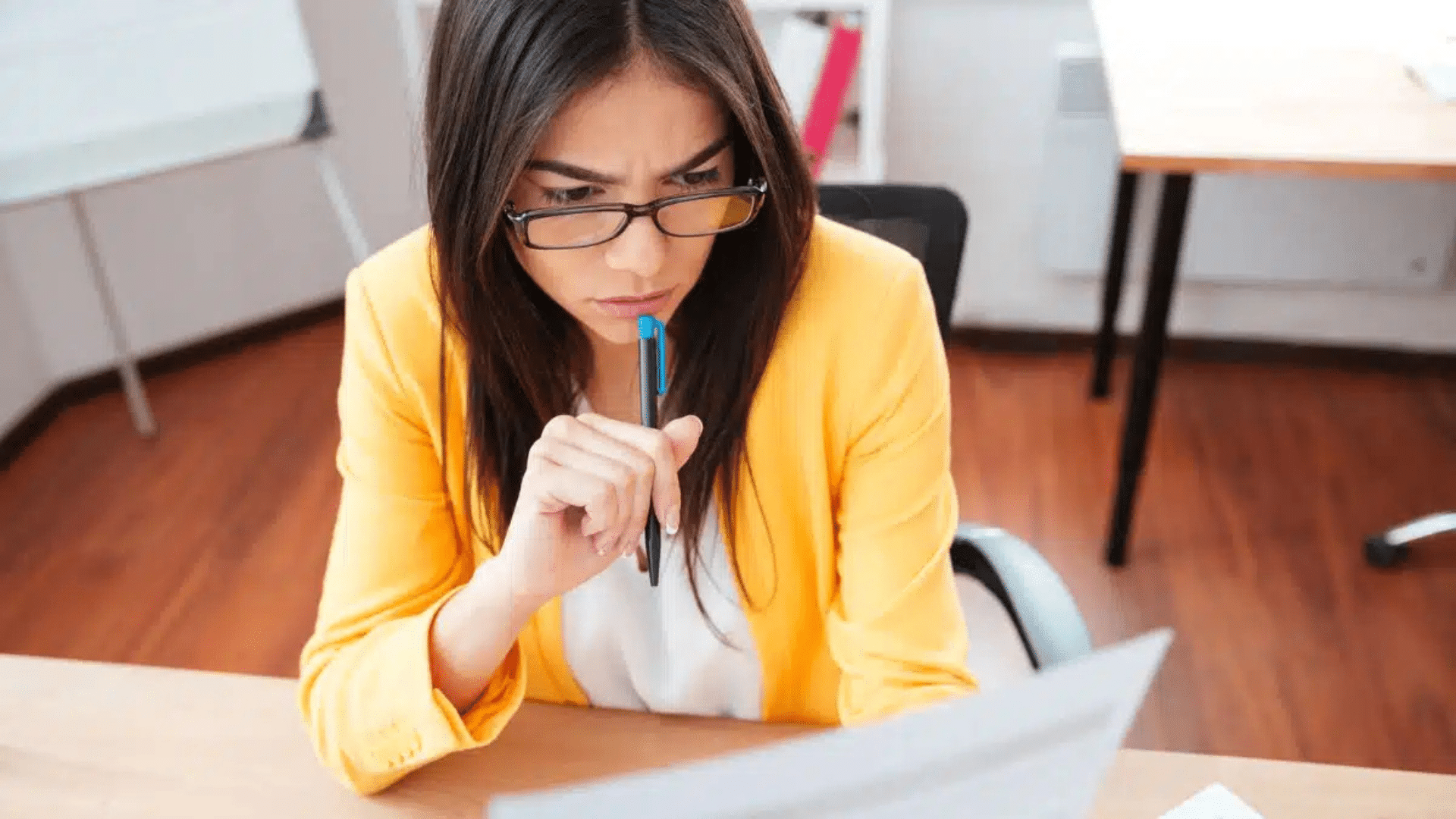 woman reviewing personality test results on computer while thinking carefully about responses and self assessment outcomes