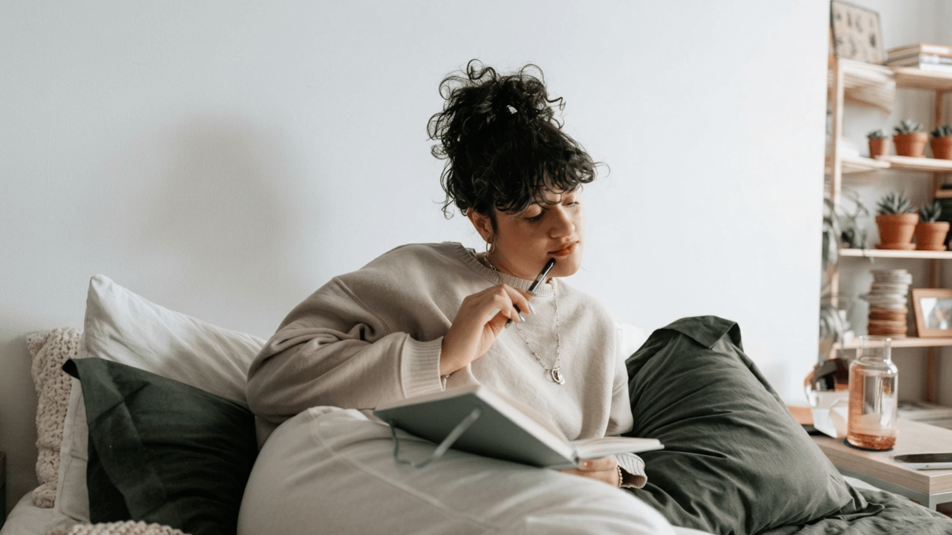 woman thinking and writing their thought in the notebook
