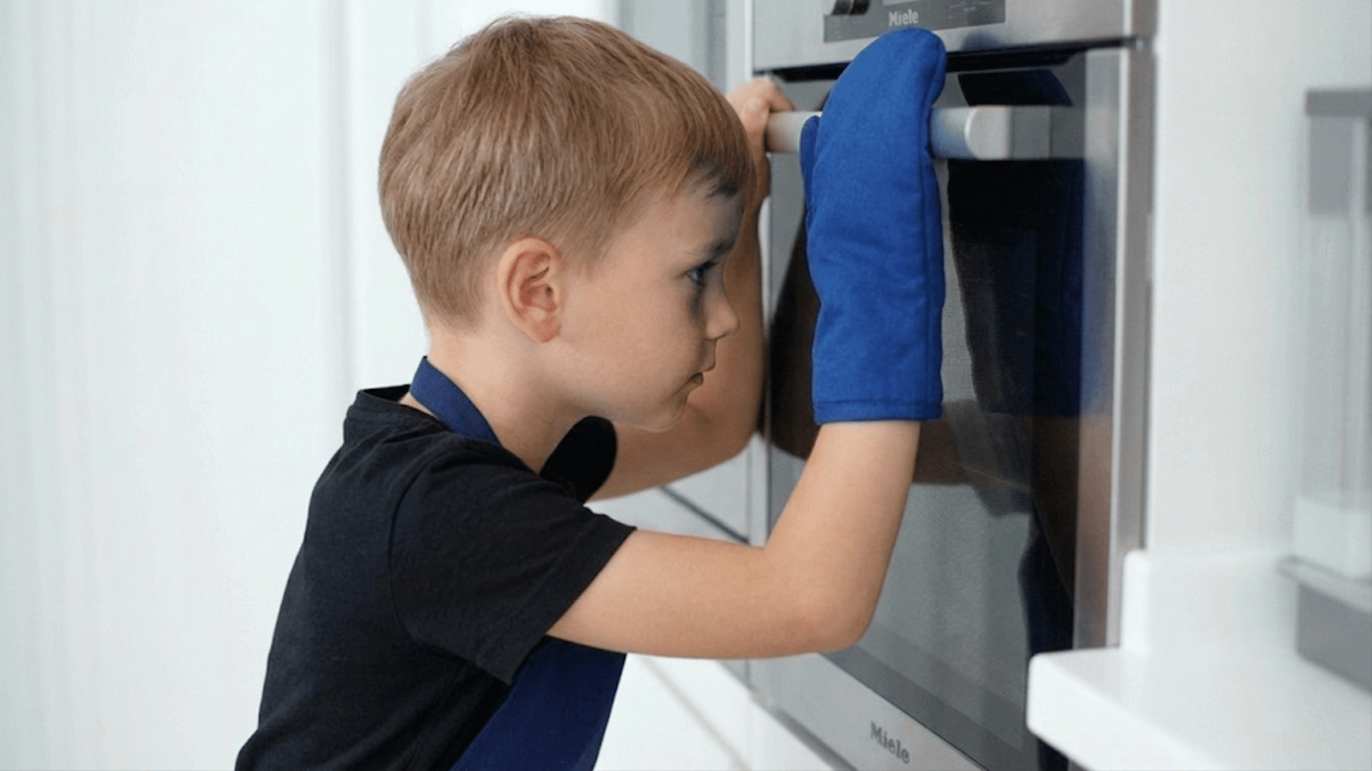 child patiently watching cookies bake in the oven while practicing waiting and self control in the kitchen